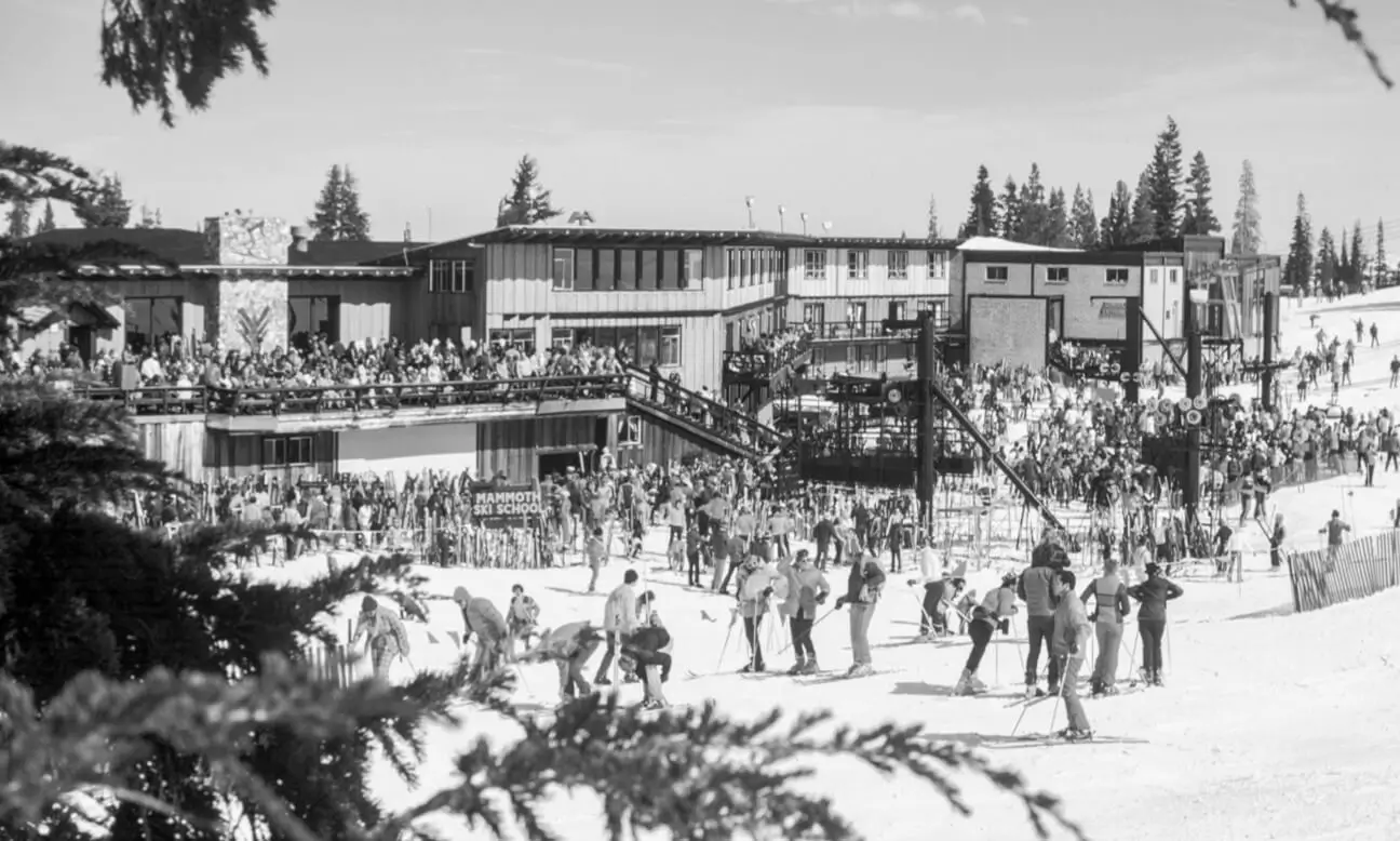 A view of Main Lodge in the 1960s with lots of skiiers in black and white